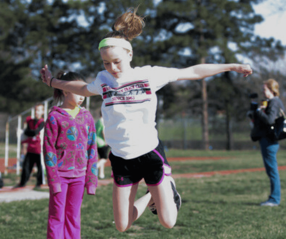 girl doing long jump